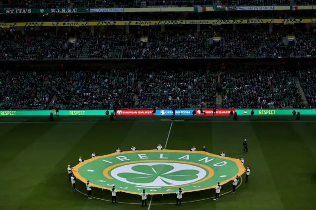 A view of the Ireland Football logo displayed on the pitch