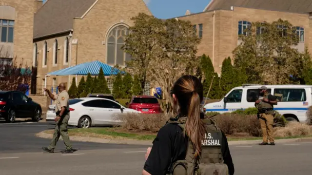 Law enforcement officers and members of the U.S. marshals work at a family reunification center after a mass shooting at the Covenant School in Nashville