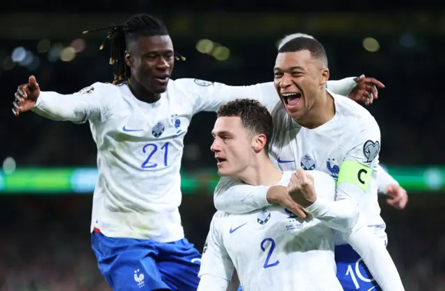 Benjamin Pavard of France celebrates with teammates Kylian Mbappe and Eduardo Camavinga