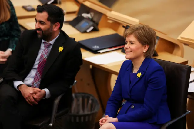 Humza Yousaf and Nicola Sturgeon sit alongside each other in the Scottish parliament