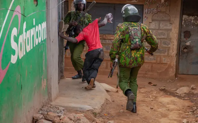 Anti-riot police officers beating a supporters of the Azimio la Umoja coalitio