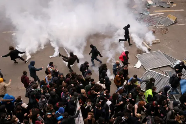 Protesters throw tear gas canisters back amid clashes last Thursday in Paris