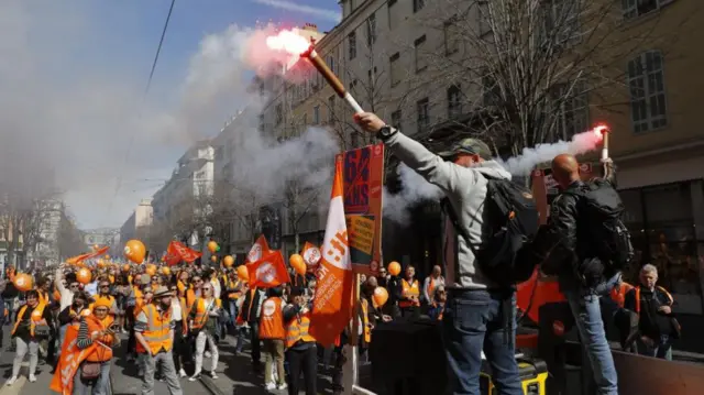 Protesters light flares during a protest against government's pension reform at Nice, France, 28 March 2023.