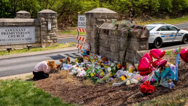 A mourner praying at temporary shrine