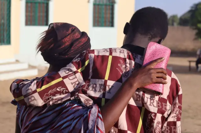 A mother hugs her son in N'Djamena on December 8, 2022 after he has been released on bail.