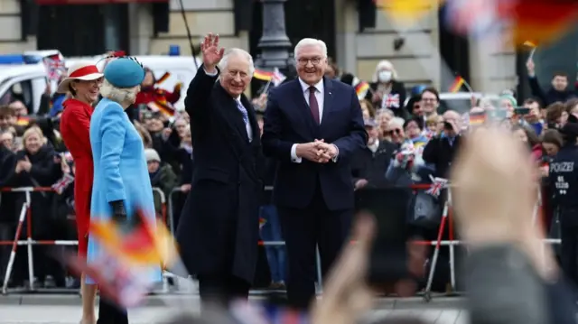 Charles waves to the crowds