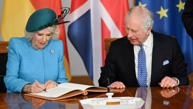 The royals sign the guest book at Bellevue