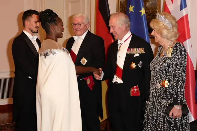 German President Frank-Walter Steinmeier, Britain's King Charles III, Camilla, Queen Consort greet Evgenij Voznyuk and Motsi Mabuse during a state banquet defilee at Schloss Bellevue presidential palace in Berlin, Germany, 29 March 2023