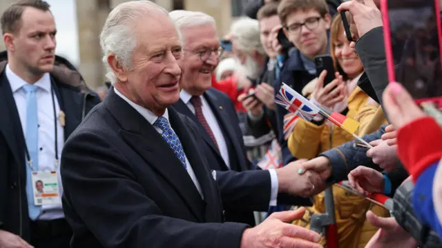 King Charles reaches out to a member of the crowd in Berlin