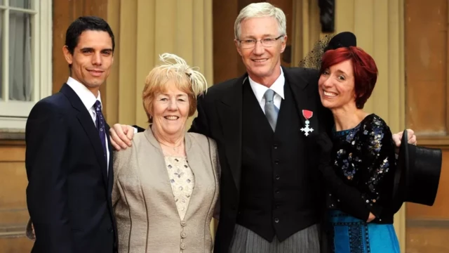 The plaudits would keep on coming for O'Grady, who was awarded an MBE in 2008. He celebrated the honour alongside his partner Andre Portasio (left), sister Sheila Rudd and daughter Sharyn Mousley