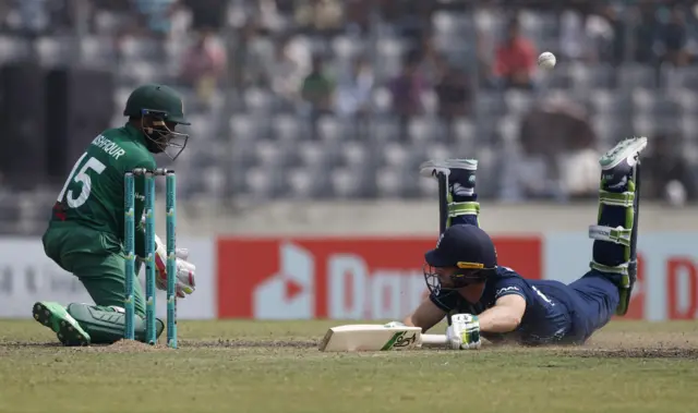 Jos Buttler dives in to make his ground