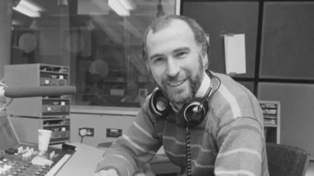 Ken Bruce sits in radio studio in January 1984
