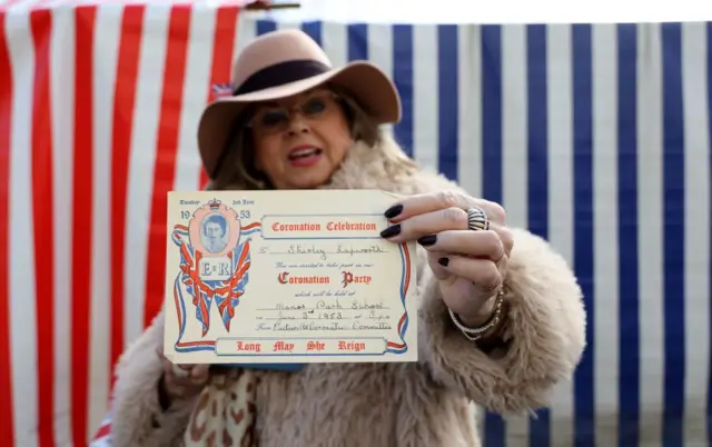 Shirley Heim, with her original coronation street party ticket for the coronation of Queen Elizabeth II in 1953, ahead of a visit by King Charles III and the Queen Consort to the Wittenbergplatz market, in Berlin, as part of their state visit to Germany