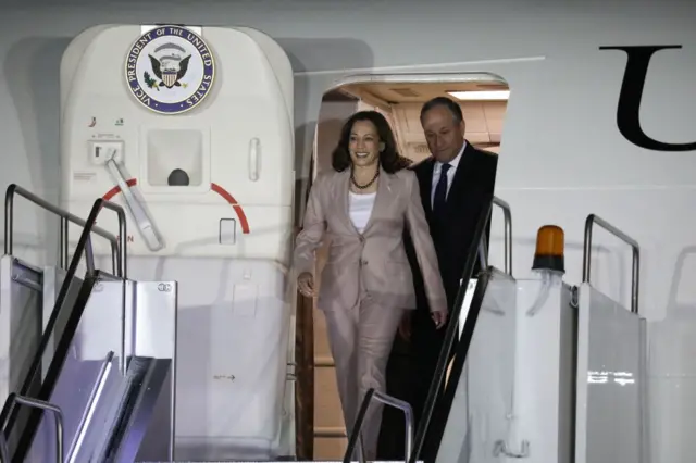 US Vice-President Kamala Harris (L) and her husband Douglas Emhoff arrive at Julius Nyerere International Airport