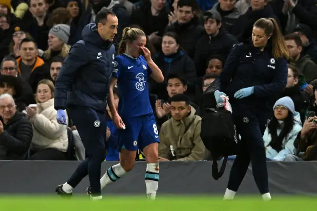 Melanie Leupolz is helped off by medical staff