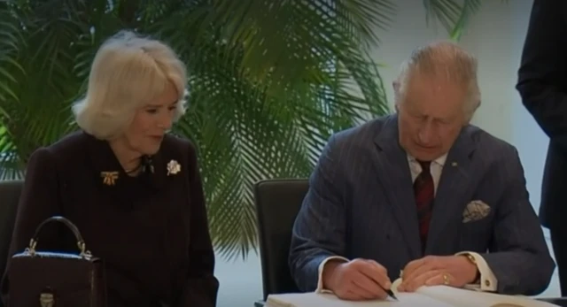 King Charles signs the guestbook at the German Bundestag