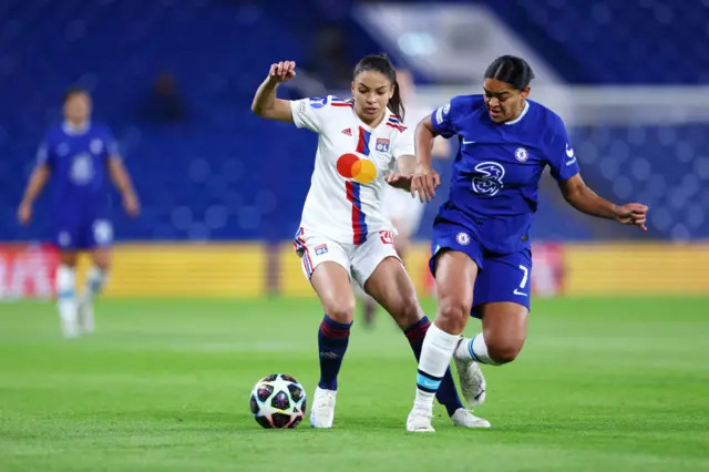 Delphine Cascarino of Olympique Lyonnais battles for possession with Jess Carter of Chelse