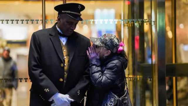 A woman talks to a doorman outside Trump Tower after former U.S. President Donald Trump's indictment by a Manhattan grand jury following a probe into hush money paid to porn star Stormy Daniels