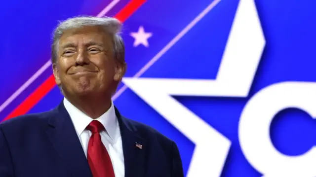 Donald Trump smiles on stage at the Conservative Political Action Conference in Maryland on 4 March 2023