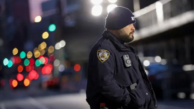 An NYPD officer stands outside the Manhattan Criminal Court