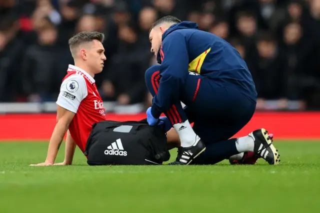 Arsenal forward Leandro Trossard receives treatment