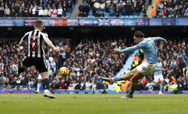 Manchester City midfielder Jack Grealish has a shot against Newcastle