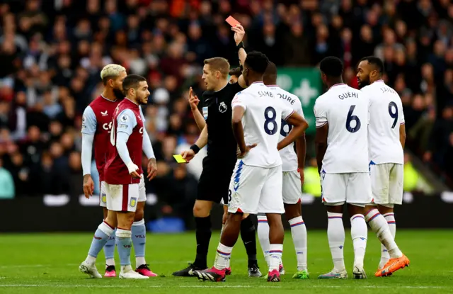 Crystal Palace's Cheick Doucoure is shown a red card by referee Craig Pawson