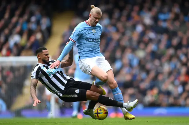 Newcastle defender Jamaal Lacelles challenges Erling Haaland