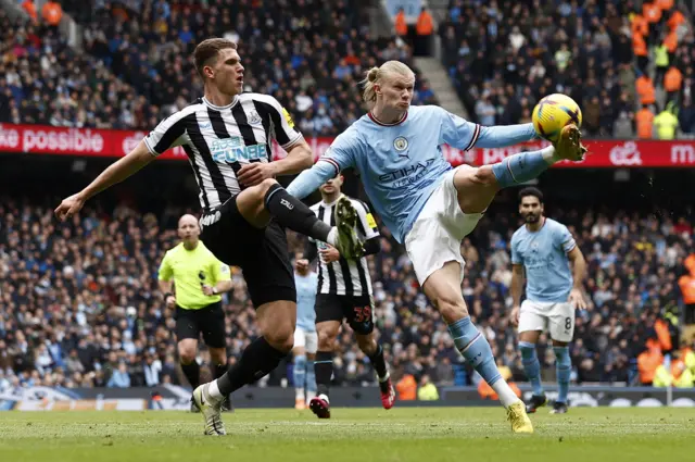 Manchester City striker Erling Haaland attempts a shot against Newcastle