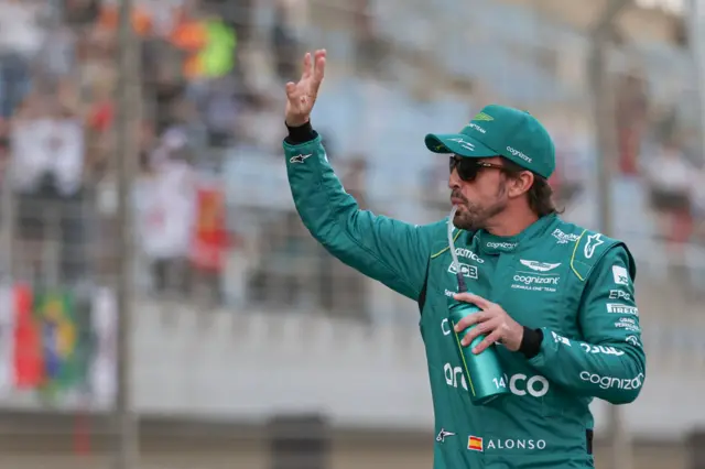 Aston Martin driver Fernando Alonso waves to fans before the Bahrain Grand Prix