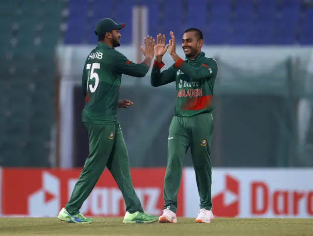 Bangladesh's Taijul Islam celebrates with Shakib Al Hasan after taking the wicket of England's Sam Curran