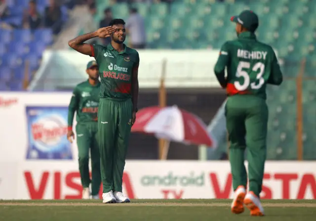 Bangladesh's Ebadot Hossain celebrates with teammates after taking the wicket of England's Dawid Malan