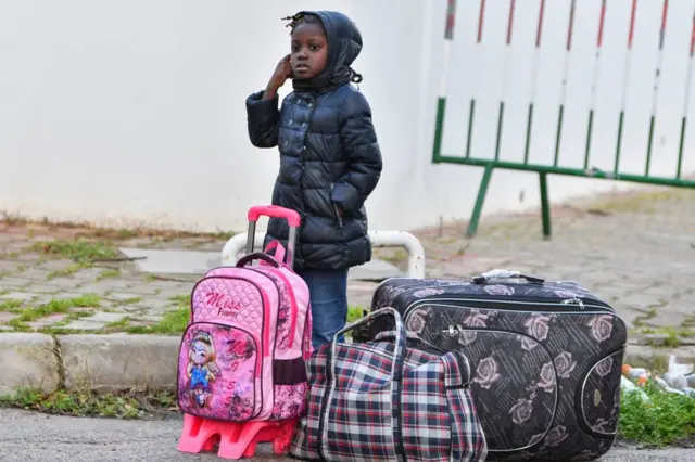 A girl waiting for a bus to the airport in Tunisia on Saturday.