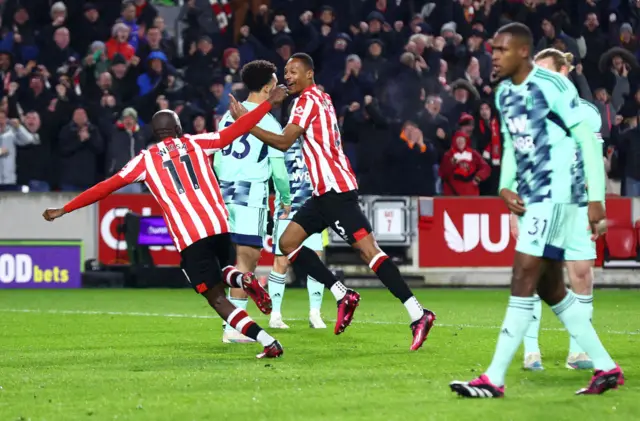 Ethan Pinnock and Yoane Wissa celebrate