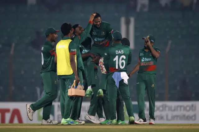 Bangladesh's Shakib Al Hasan celebrates with teammates after taking the wicket of England's Rehan Ahmed