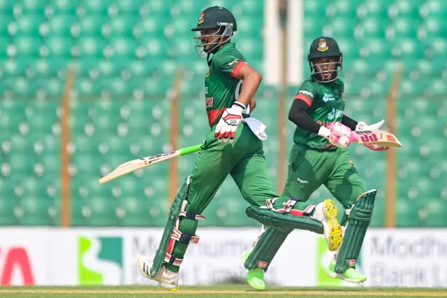 Bangladesh's Najmul Hossain Shanto (L) and Mushfiqur Rahim run between the wickets during the third one-day international (ODI) cricket match between Bangladesh and England at the Zahur Ahmed Chowdhury Stadium in Chittagong