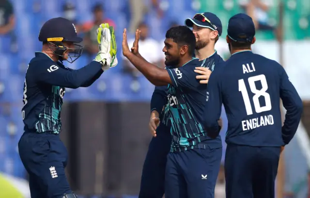 England's Rehan Ahmed celebrates with teammates after taking the wicket of Bangladesh's Mehidy Hasan Miraz