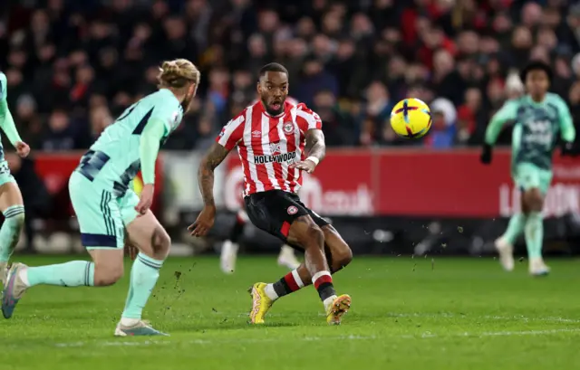 Ivan Toney attempts a shot at goal from near the half-way line.