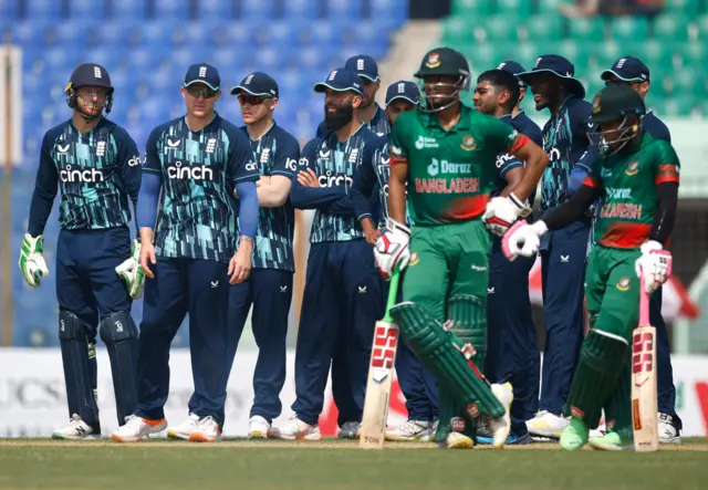 England players await for the DRS decision for the wicket of Bangladesh's Najmul Hossain Shanto