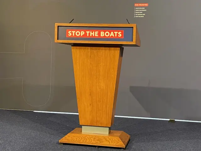 Lectern which reads 'stop the boats'