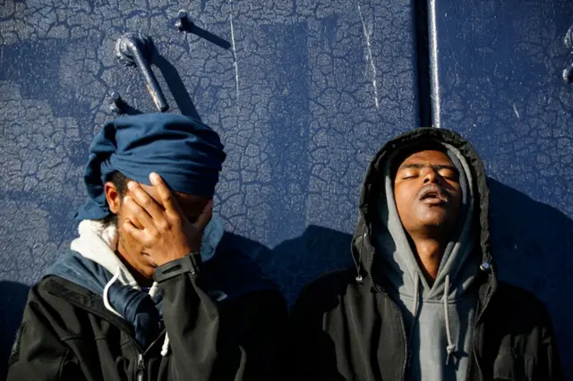 Migrants wait on board the Abeille Languedoc ship after being rescued after the generator of a migrant boat broke down in French waters while they were trying to cross the Channel illegally to Britain, in 2022.