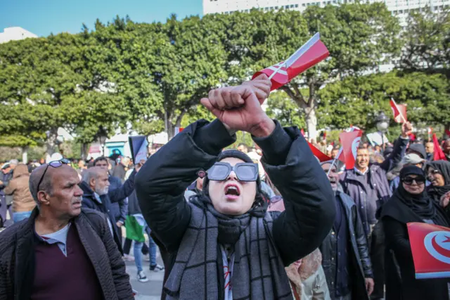 A young woman shouts slogans during a demonstration held by the National Salvation Front opposition alliance, in Tunis, Tunisia, on March 5, 2023, to call for the release of arrested and detained opposition figures deemed critical of President Kais Saied.