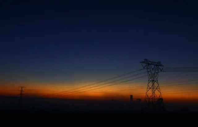 View of South African utility Eskom's electricity pylons during dawn as frequent power outages implemented by Eskom due to its aging coal-fired plants continue, in Johannesburg, South Africa, February 25, 2023