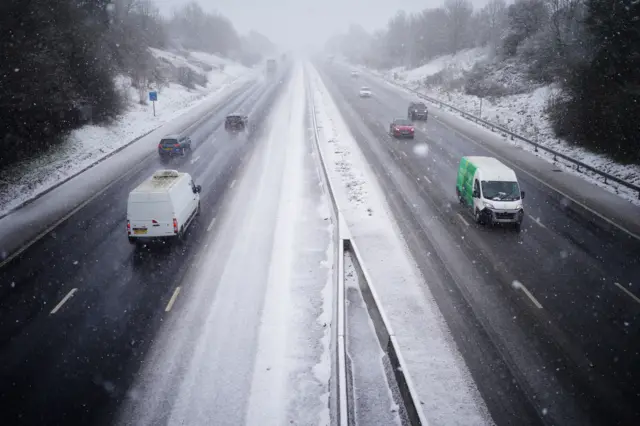 Cars driving through snow on the the M5 motorway near Taunton