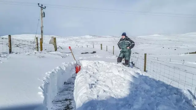 Clearing a path through snow drifts in Shetland on Wednesday