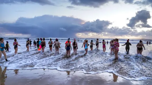 A group of women swimmers brave the freezing conditions as they gather to celebrate International Women's Day at King Edward's Bay, near Tynemouth