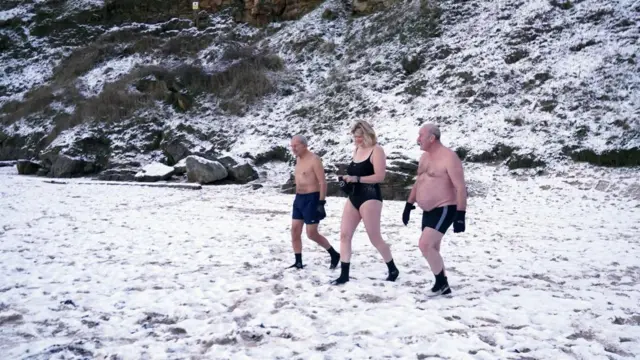 Early morning swimmers brave the cold at King Edward's Bay, near Tynemouth on the North East coast of England