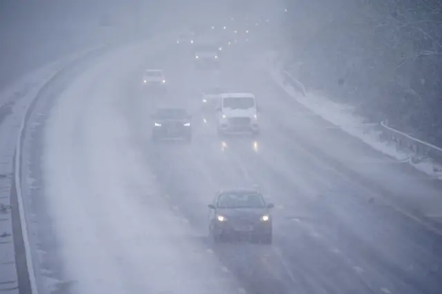 Cars driving through snow on the the M5 motorway near Taunton