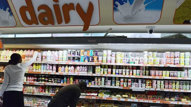 Consumers shop for dairy products in a supermarket in Nairobi