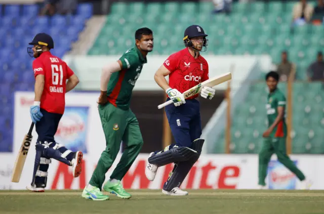 England's Jos Buttler and Phil Salt in action as they run between the wickets as Bangladesh's Nasum Ahmed looks on